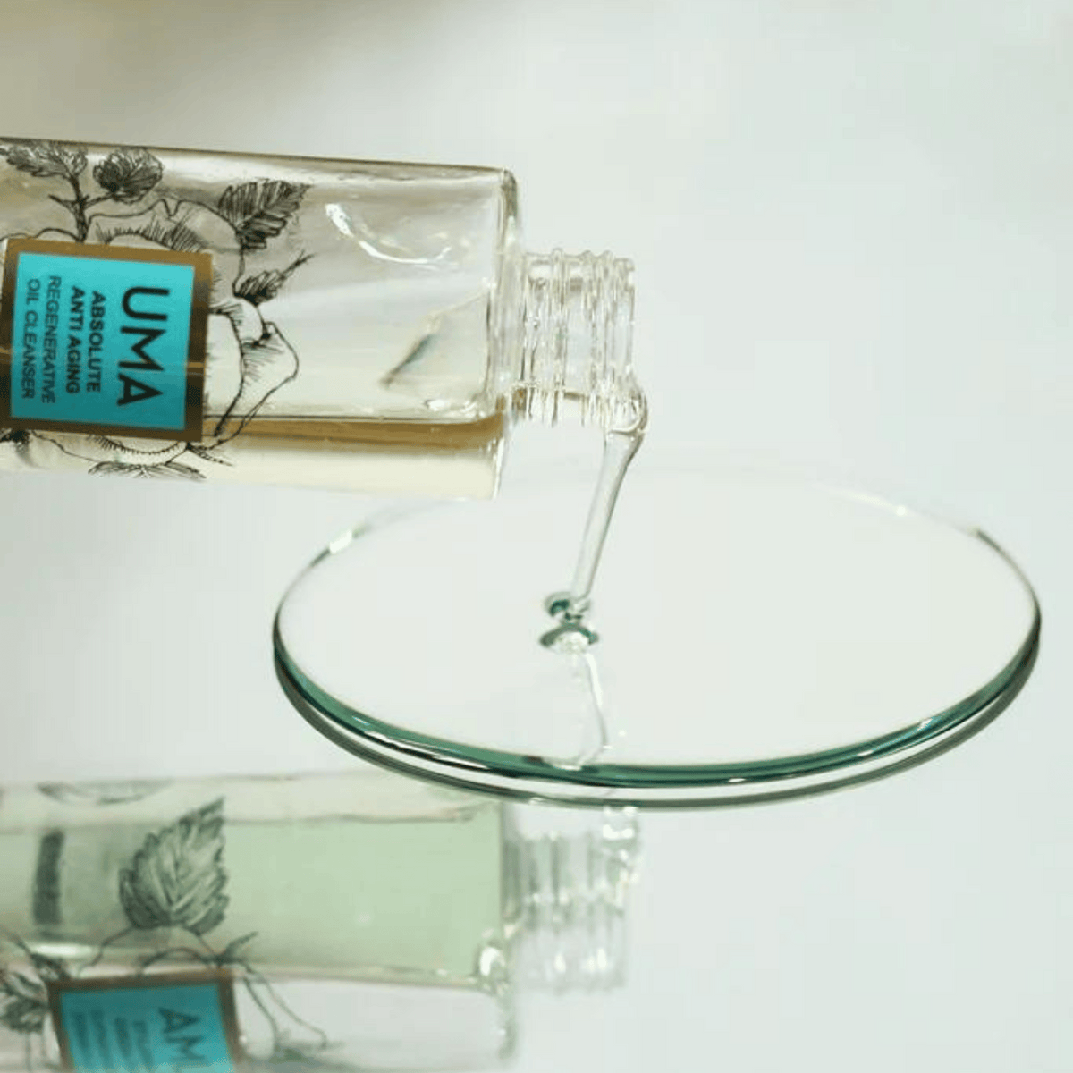 Bottle of UMA Oil Cleanser pouring out.