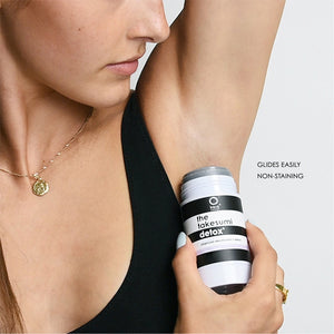 woman putting on deodorant