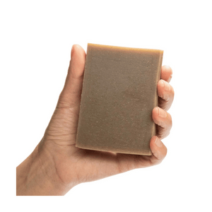 ground soap aum in a hand