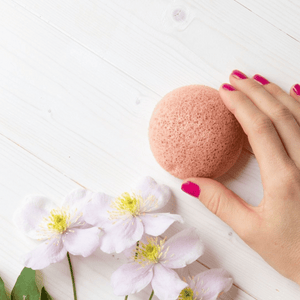 konjac sponge pink clay with hand and flower