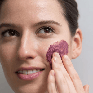 pretty lady using purple exfoliate