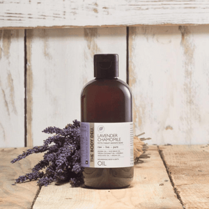 body oil on wood with lavender plants