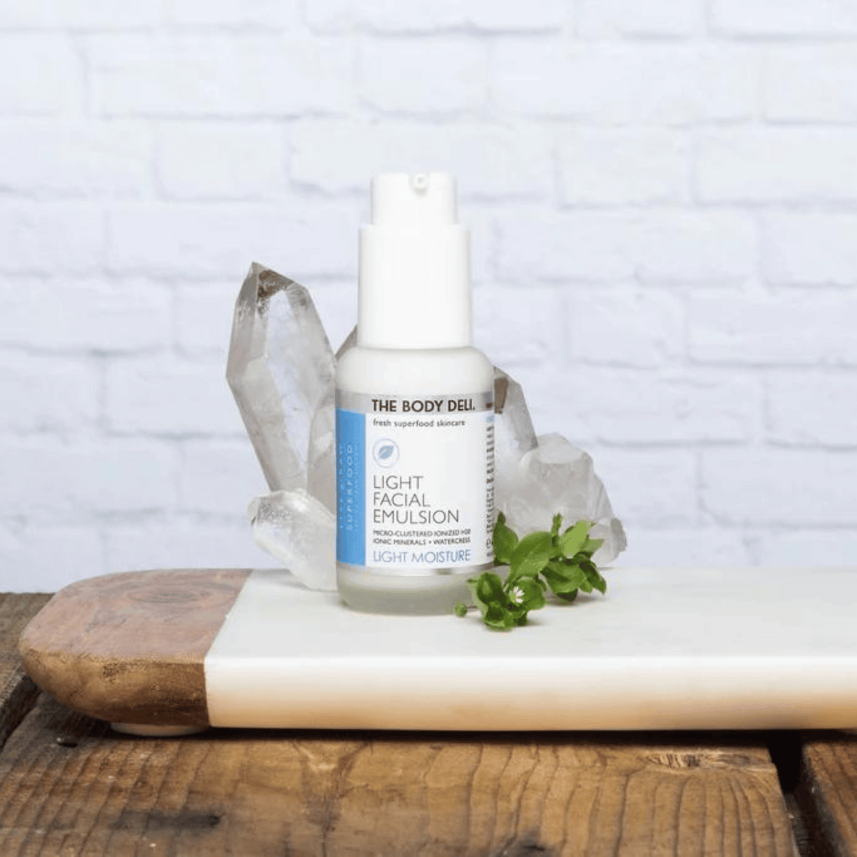 Moisturizer on tray with crystal and plant