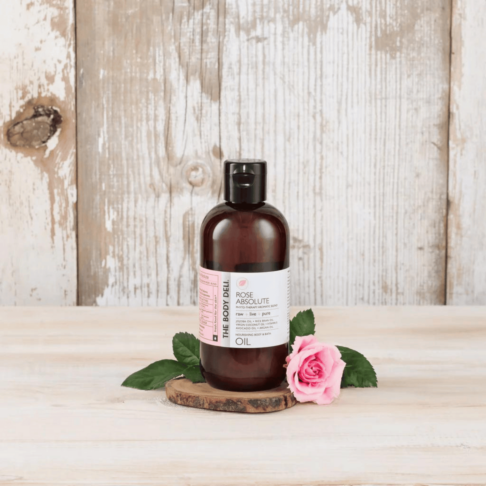 body oil with roses on tray