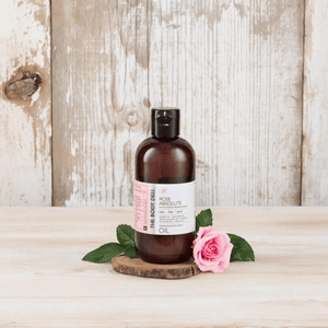 body oil with roses on tray