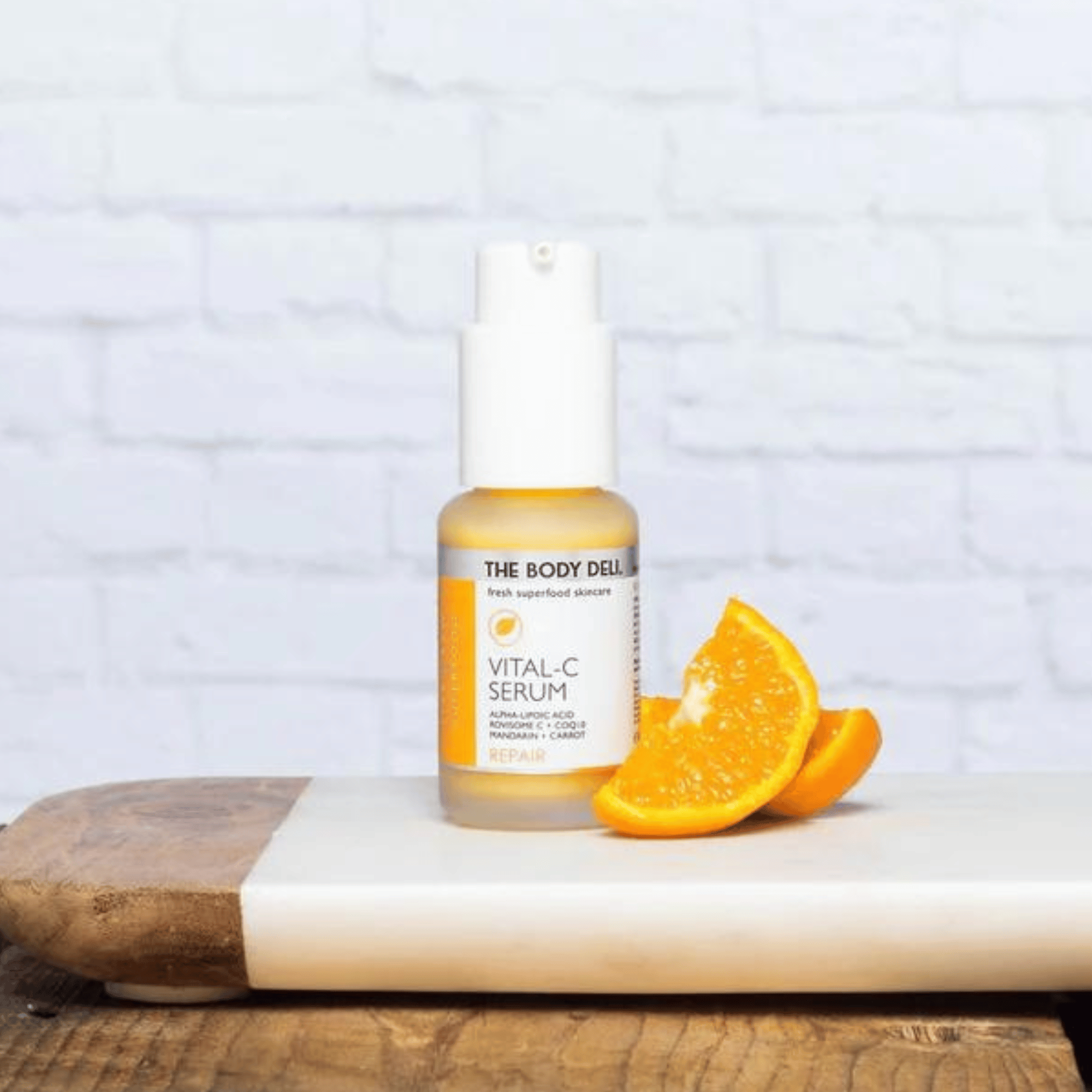 body deli vital c serum photo with oranges on a tray